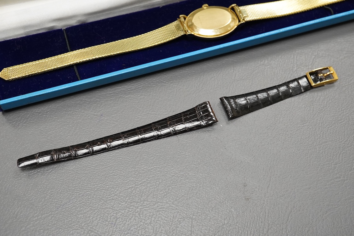 A gentleman's 18ct Girard-Perregaux manual wristwatch, oval brushed gilt dial with raised hour baton marks, seventeen jewels movement, signed, on an associated gilt metal articulated bracelet, in original case.